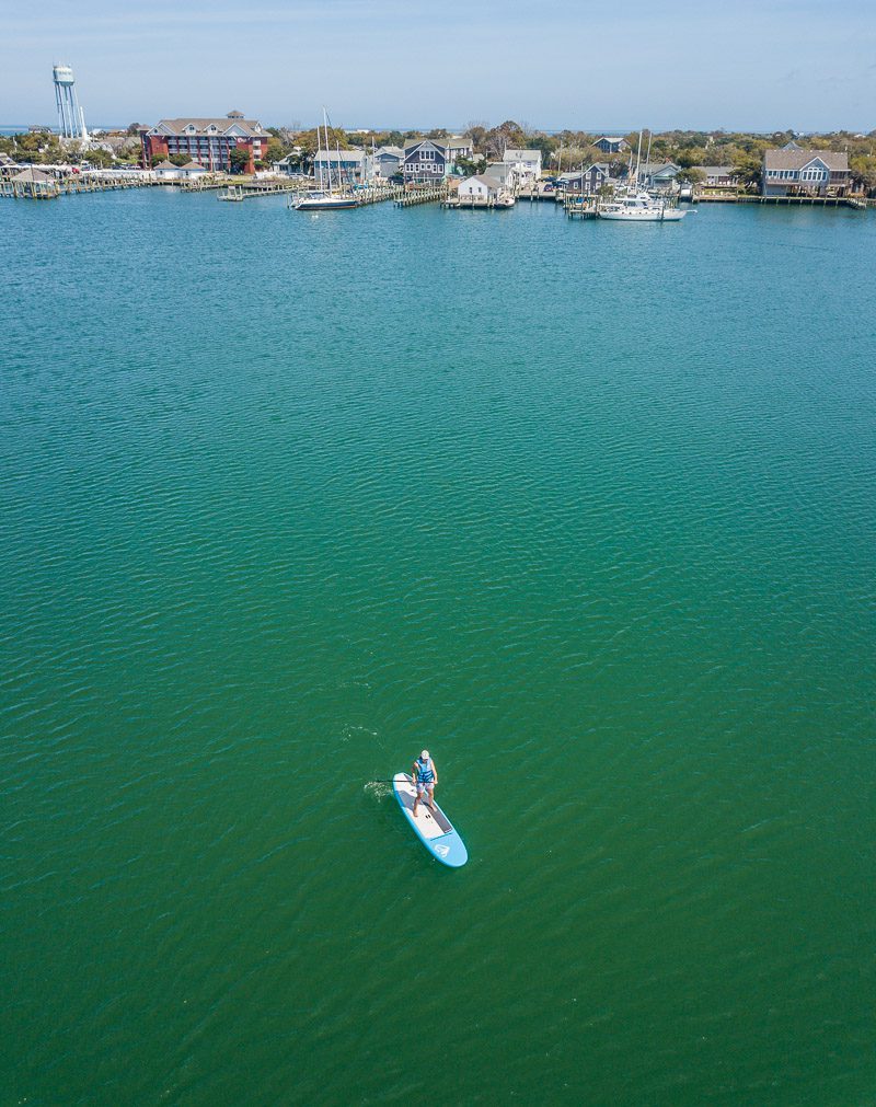 Paddle boarder in a harbor waterfront