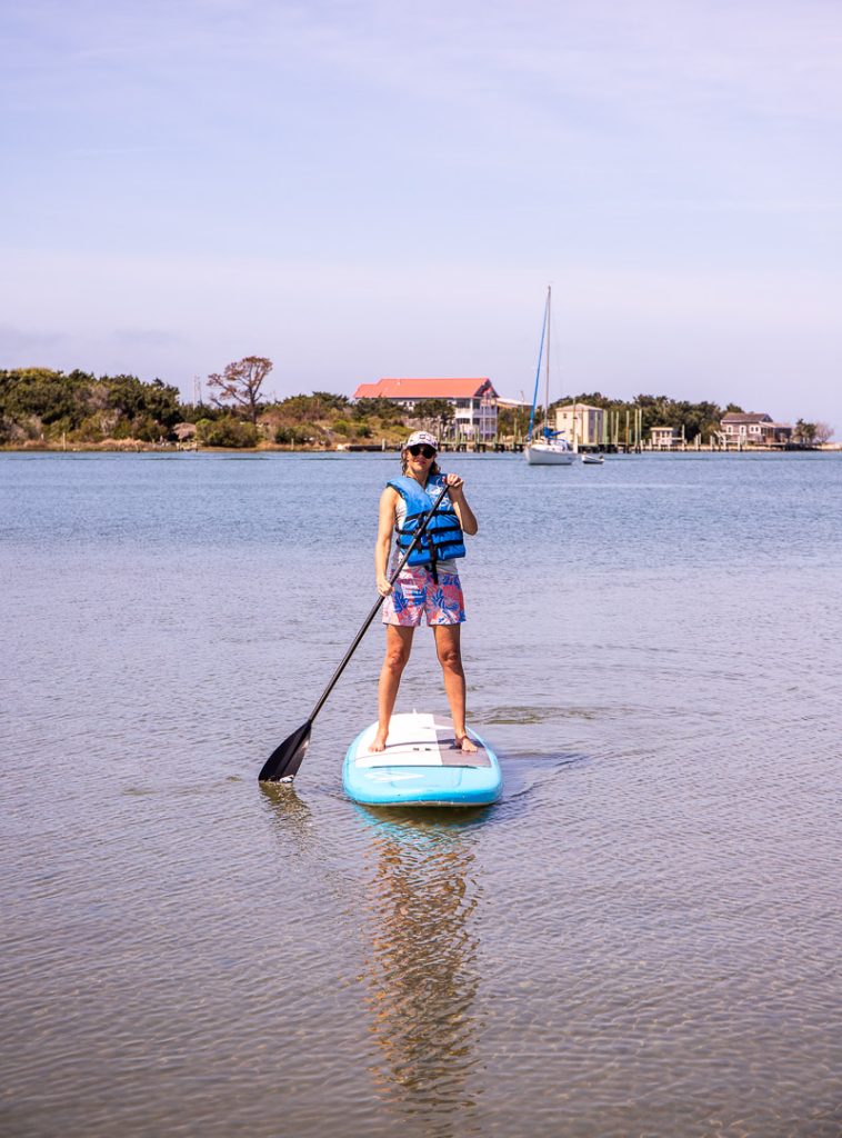 Woman doing stand-up paddle boarding on a lake