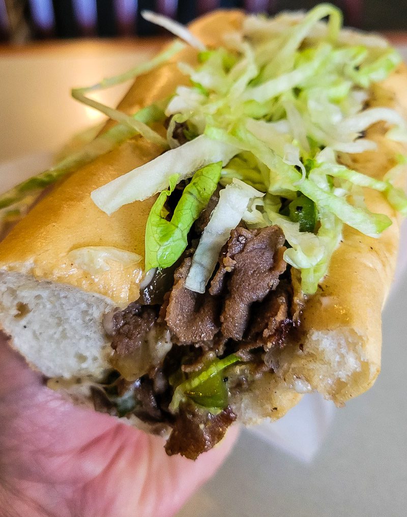 Philly cheesesteak sandwich with lettuce