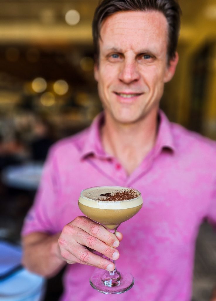 Man holding a glass of Espresso Martini