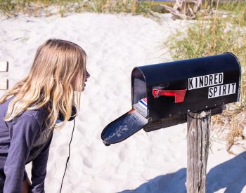 Girl looking inside a mailbox