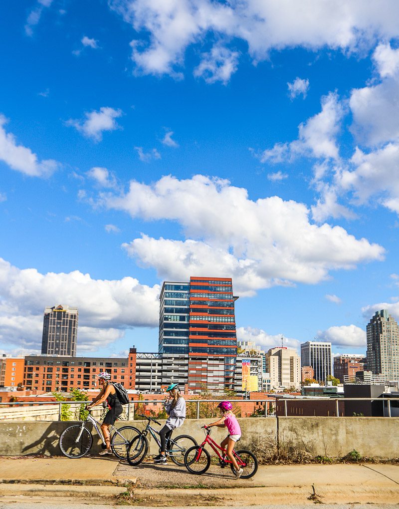 Family biking through a city