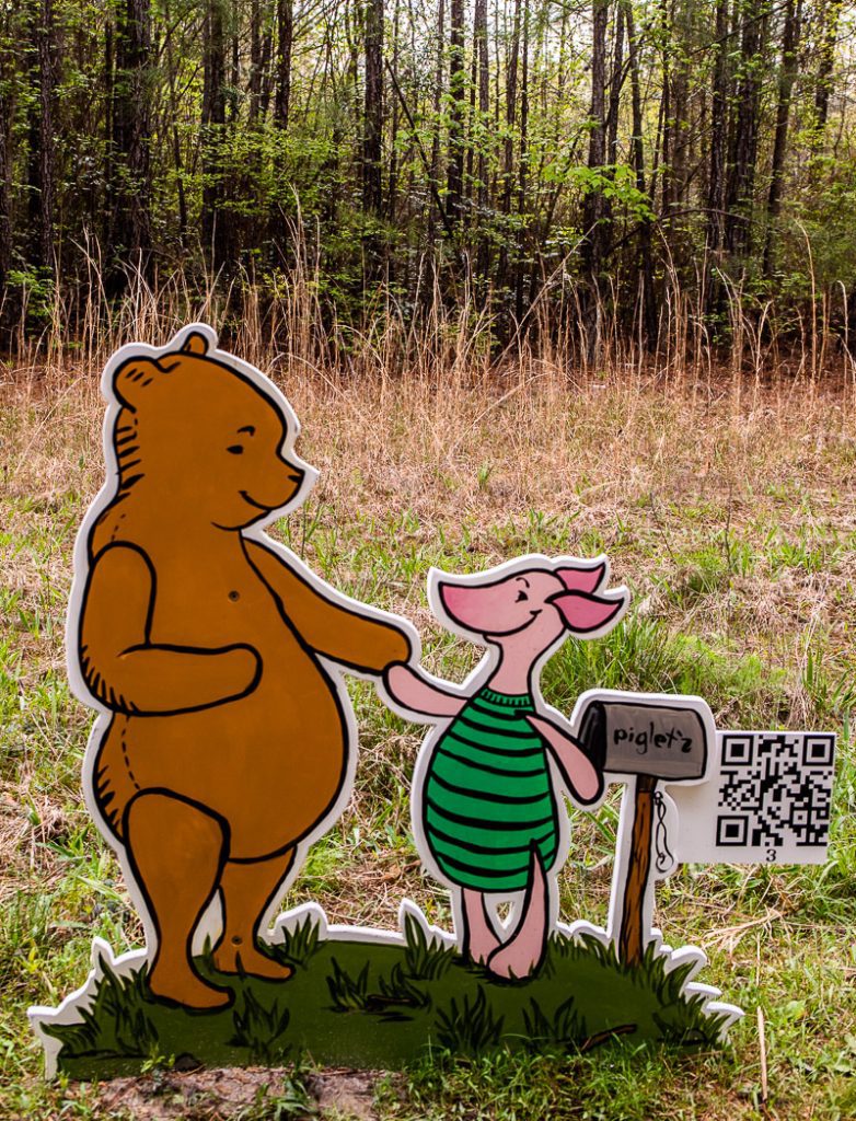 Cardboard cutout of a Winnie the Poo in a forest