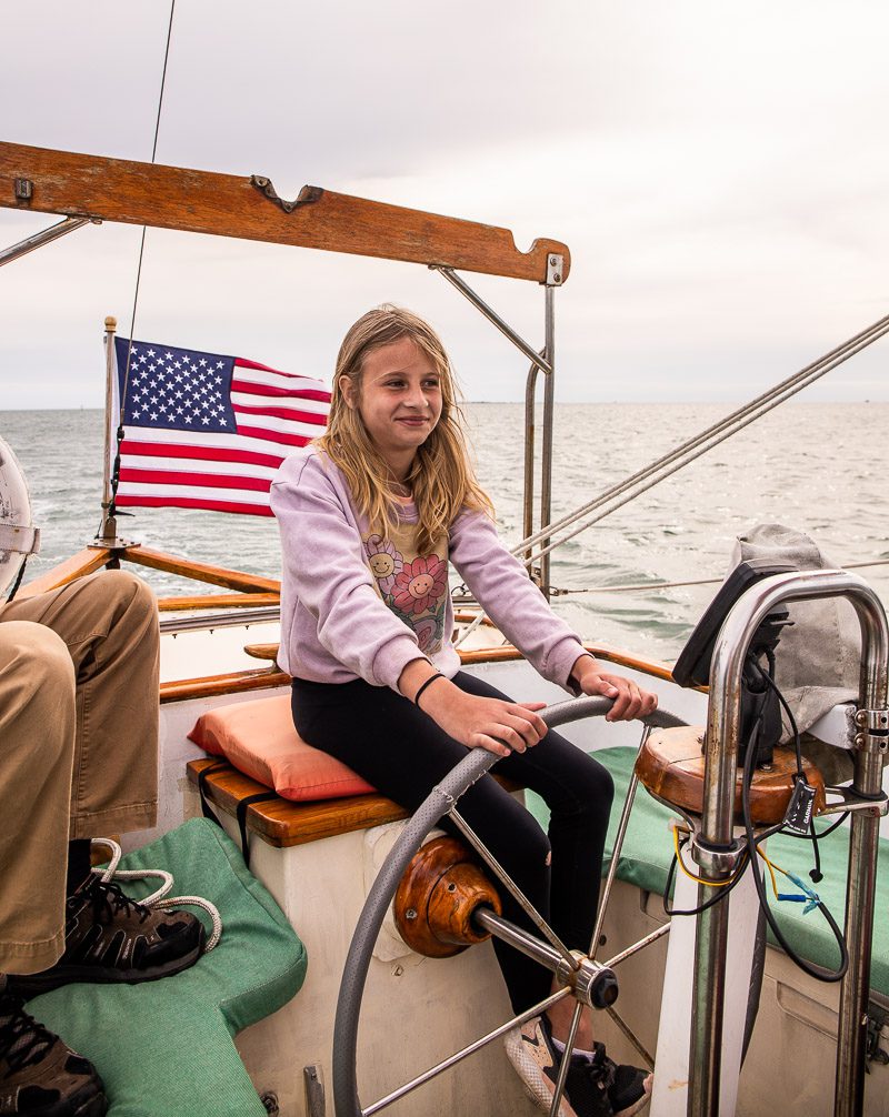 Young girl sailing a sail boat