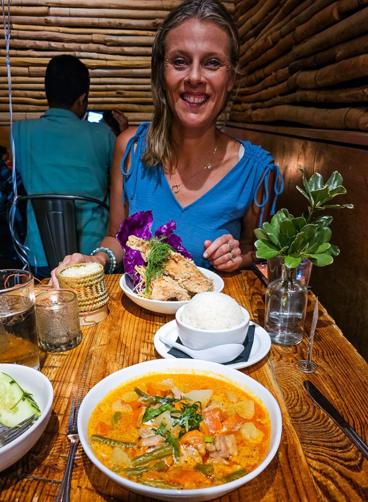 Woman having dinner with a bowl of curry