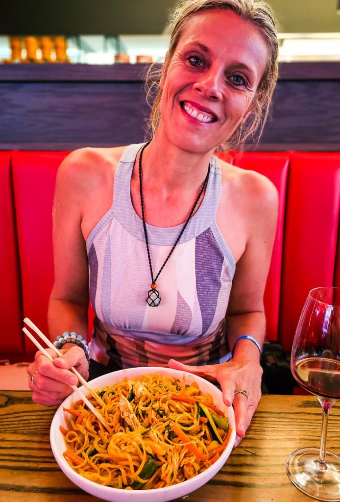 Woman eating a bowl of noodles