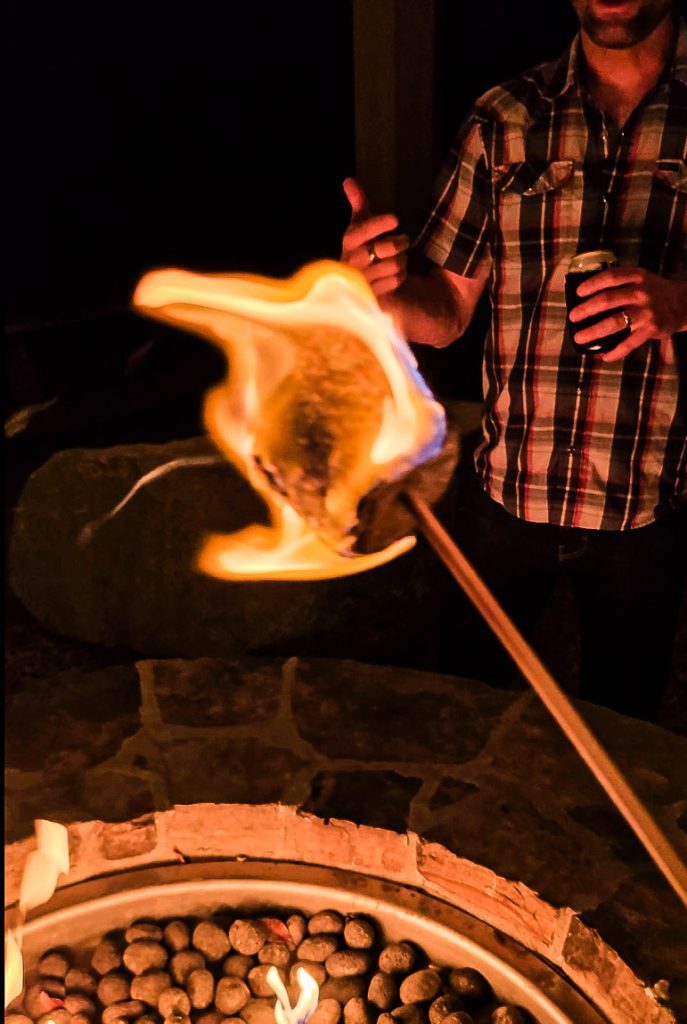 A marshmallow on a stick over a fire