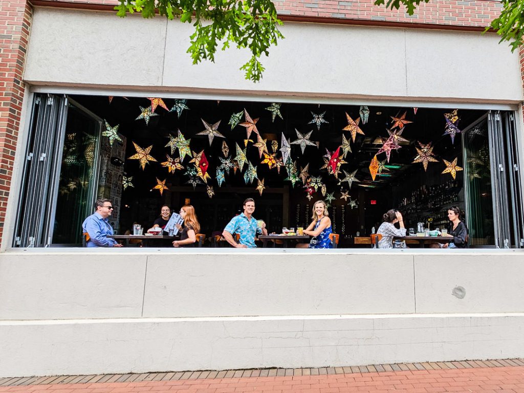 People dining in a restaurant with stars hanging from the ceiling