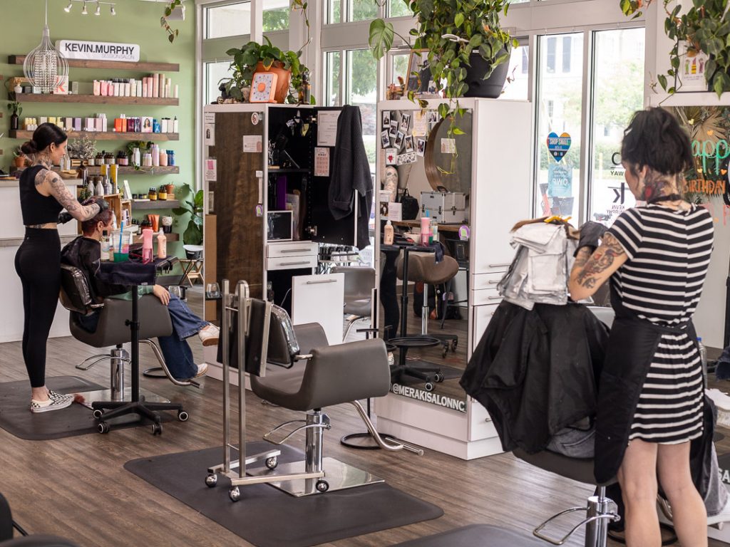 People getting their hair cut in a salon