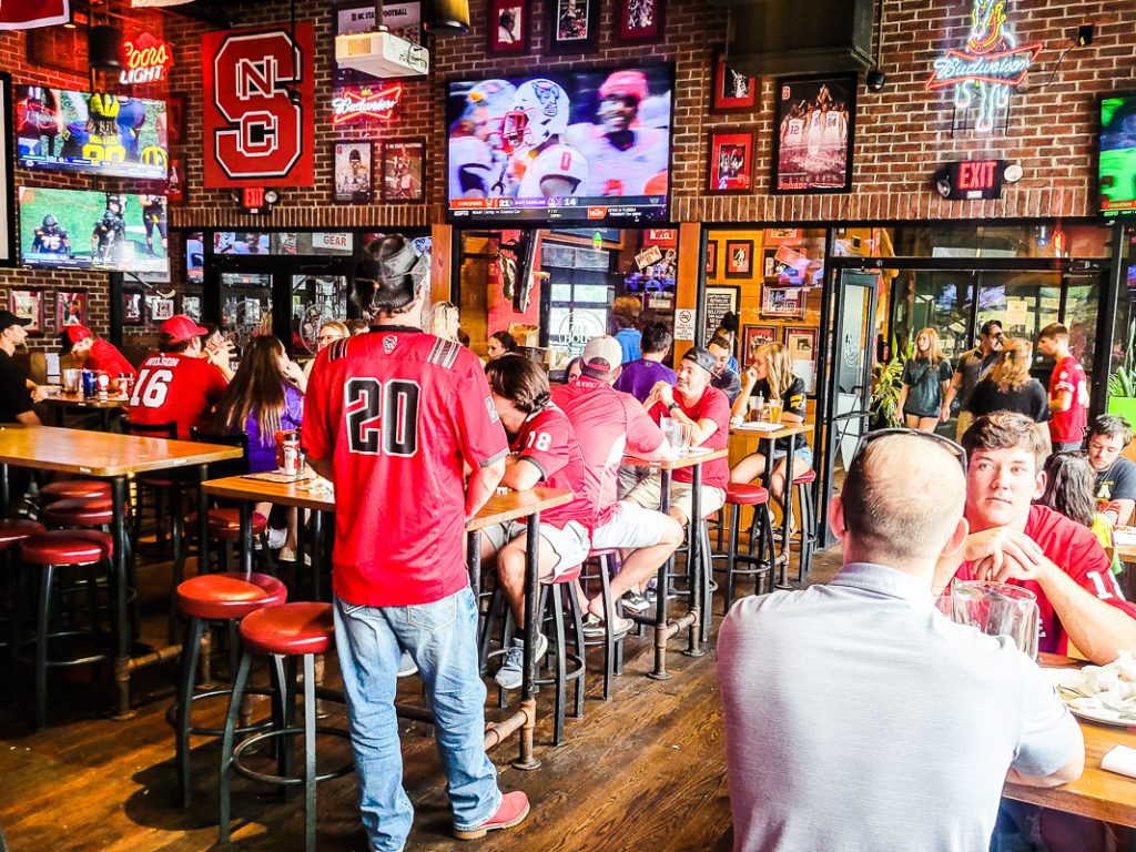 People eating and drinking in a college sports bar
