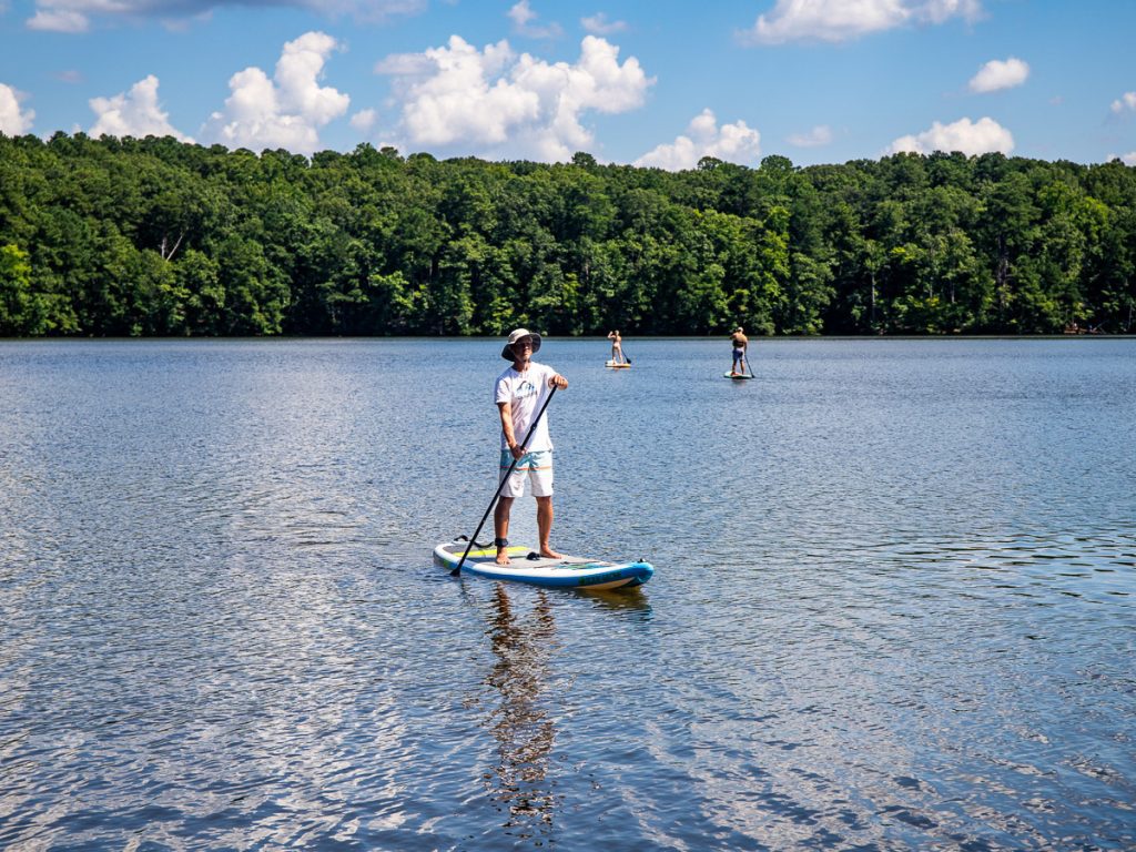 Man on a stand-up paddle board on a lake