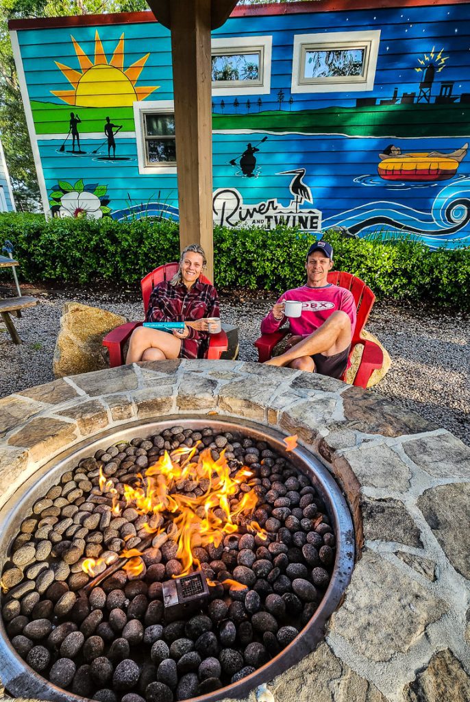 Couple having coffee by a firepit