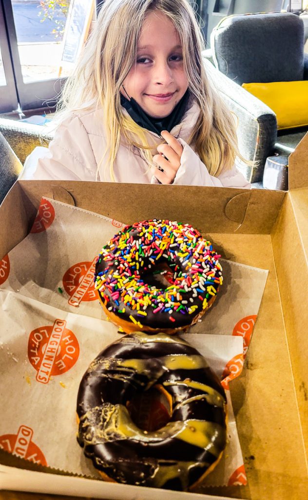 Girl with two donuts in a box
