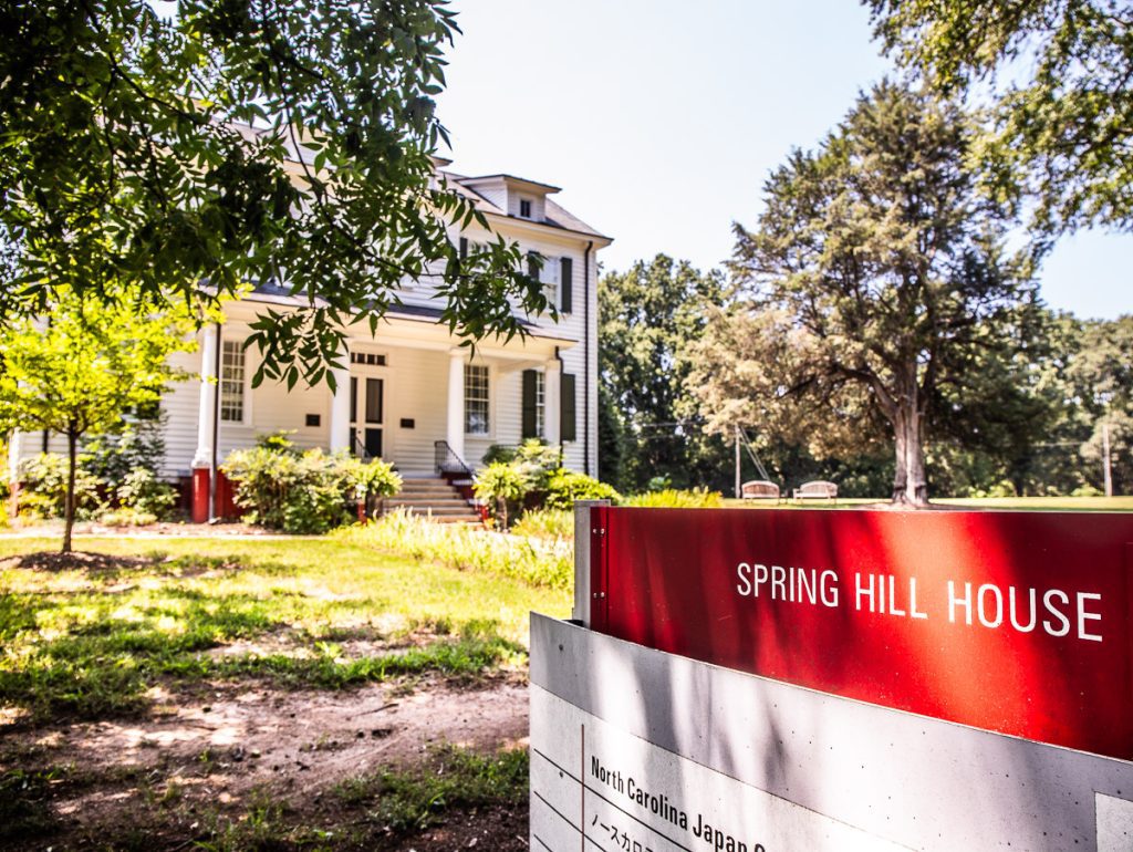 Sign in front of a white house saying Spring Hill House