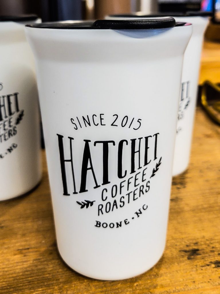White coffee cup that says Hatchet