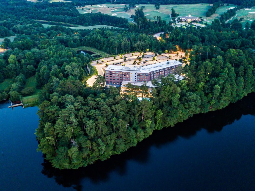 Hotel on the edge of a lake surrounded by forest