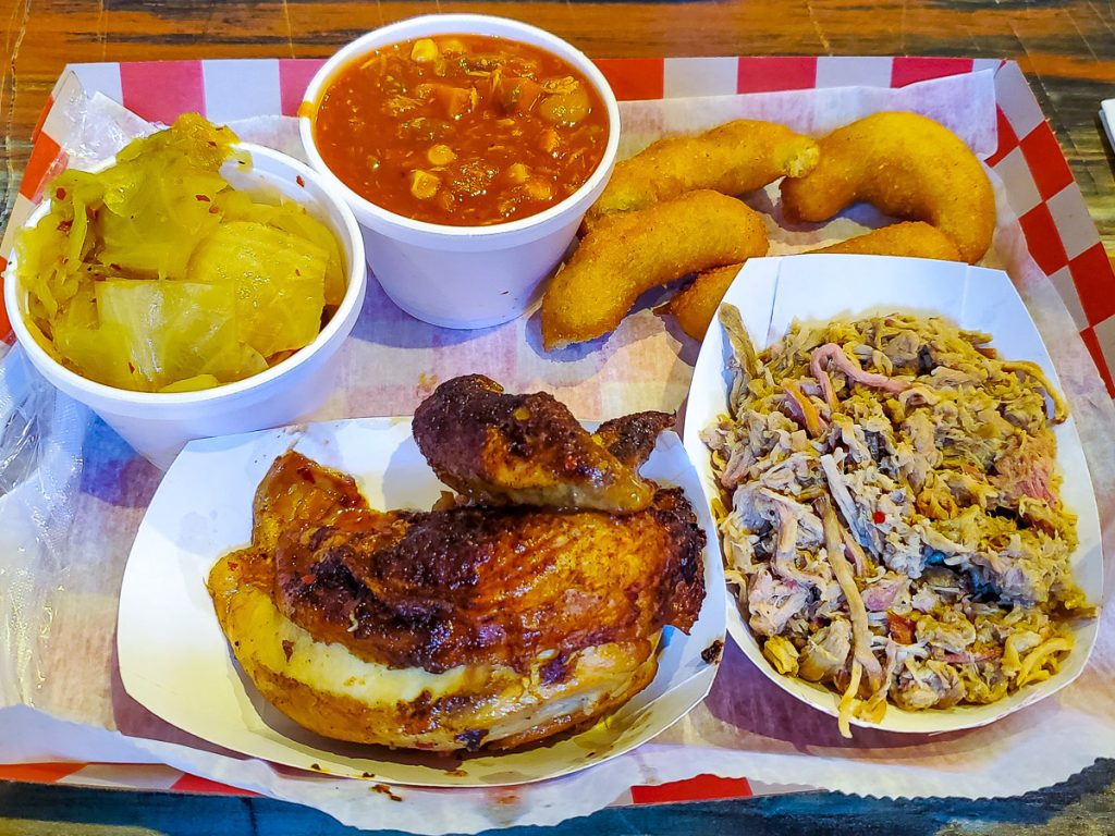 Bbq chicken and pork and hushpuppies on a tray