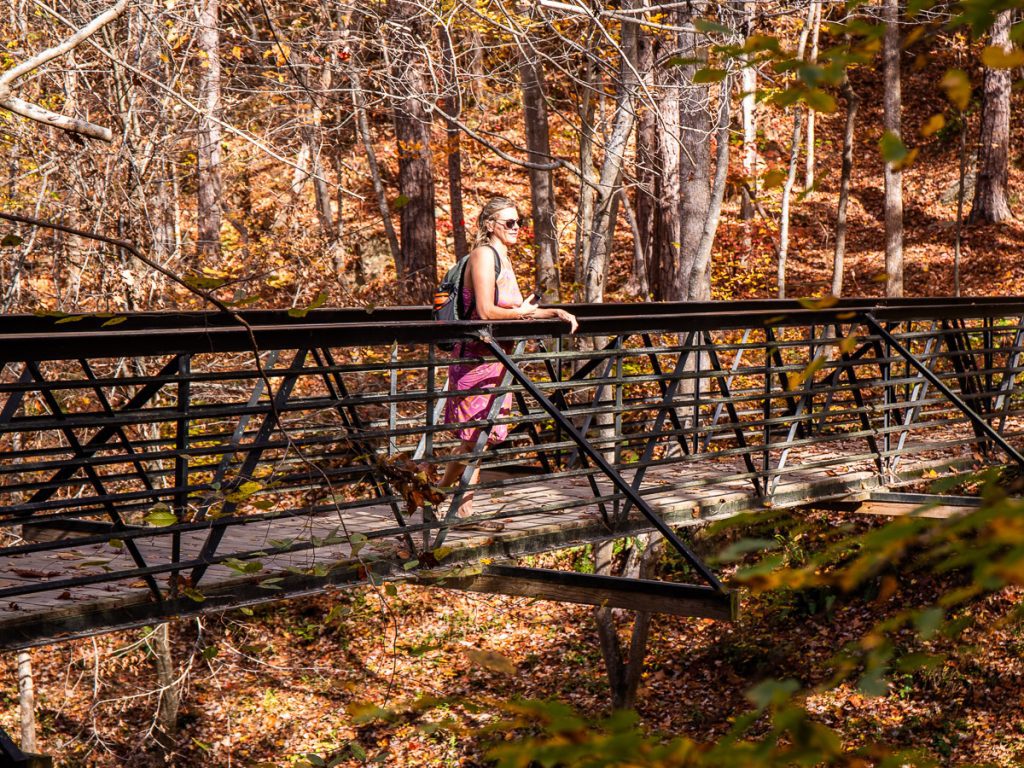 Woman standing on a bridge in the woods