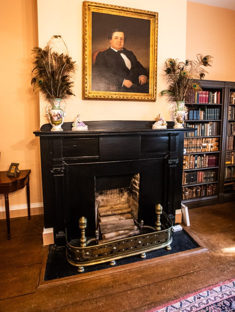 Antique fireplace and portrait hanging above