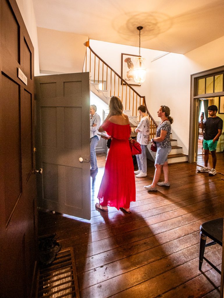 People touring a historic home in the foyer