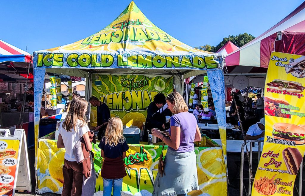 People ordering lemonade at a festival