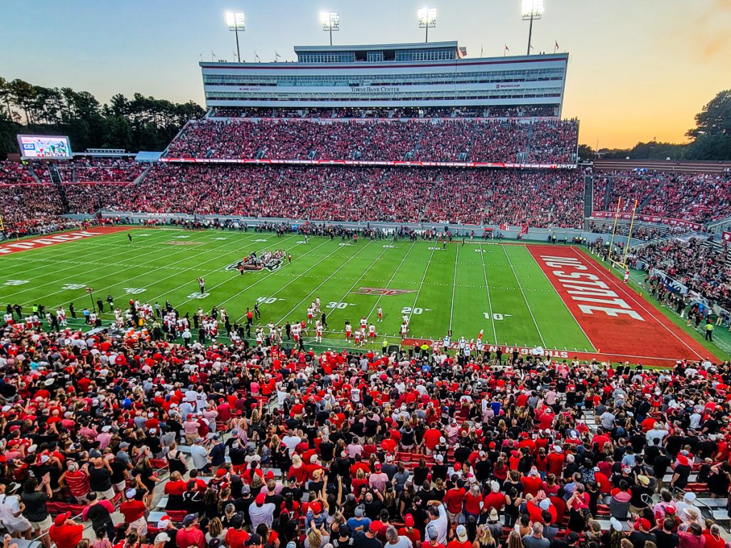 College football stadium with fans watching a game at NC State University.