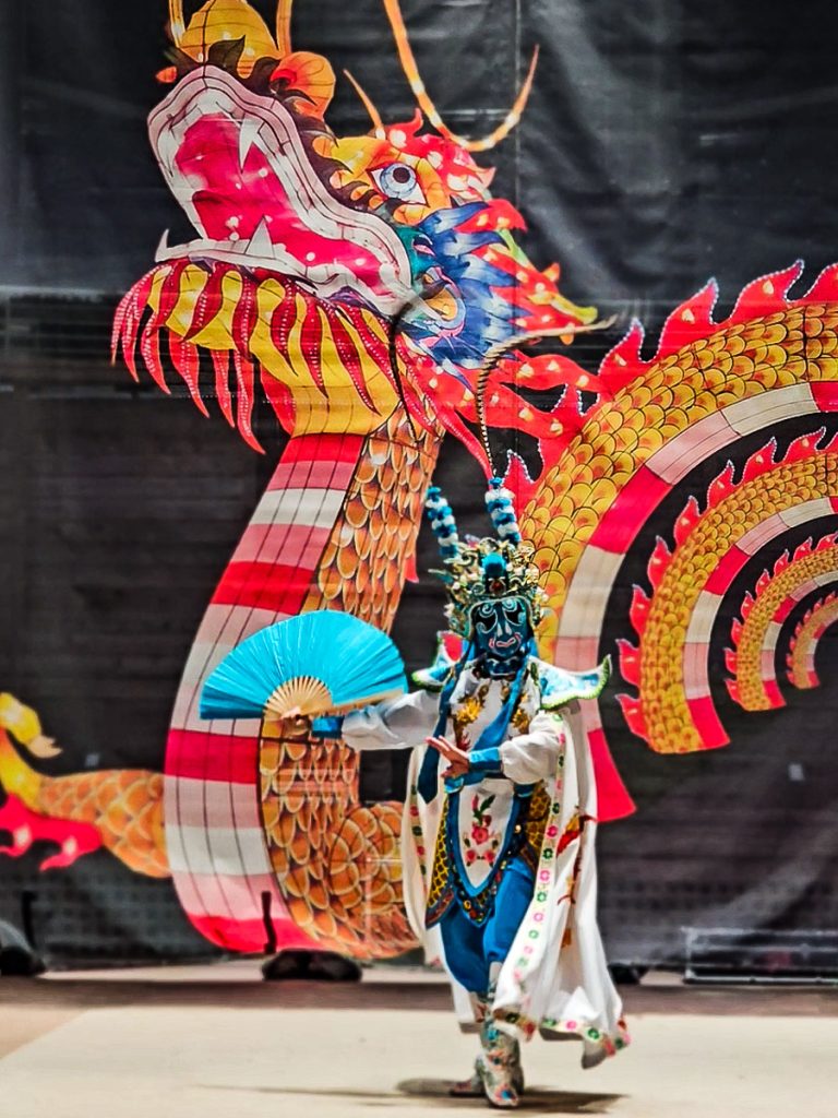 Chinese man dancing at a festival.