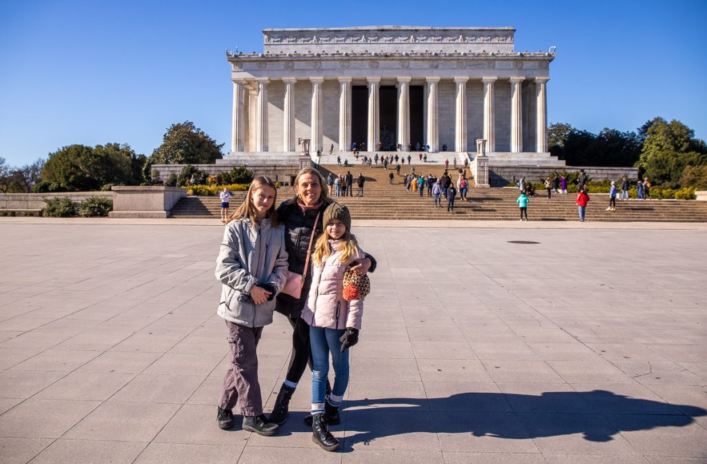 Mom and daughters in front of the Abraham Lincoln Memorial in Washington DC.