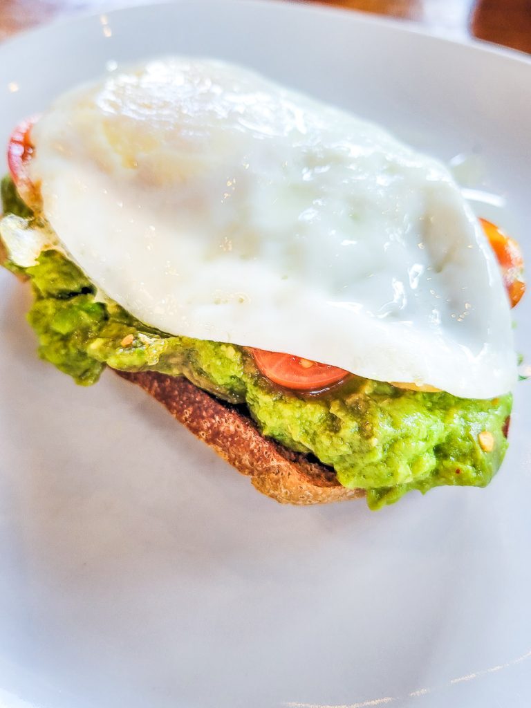 Fried egg on top of avocado on toast
