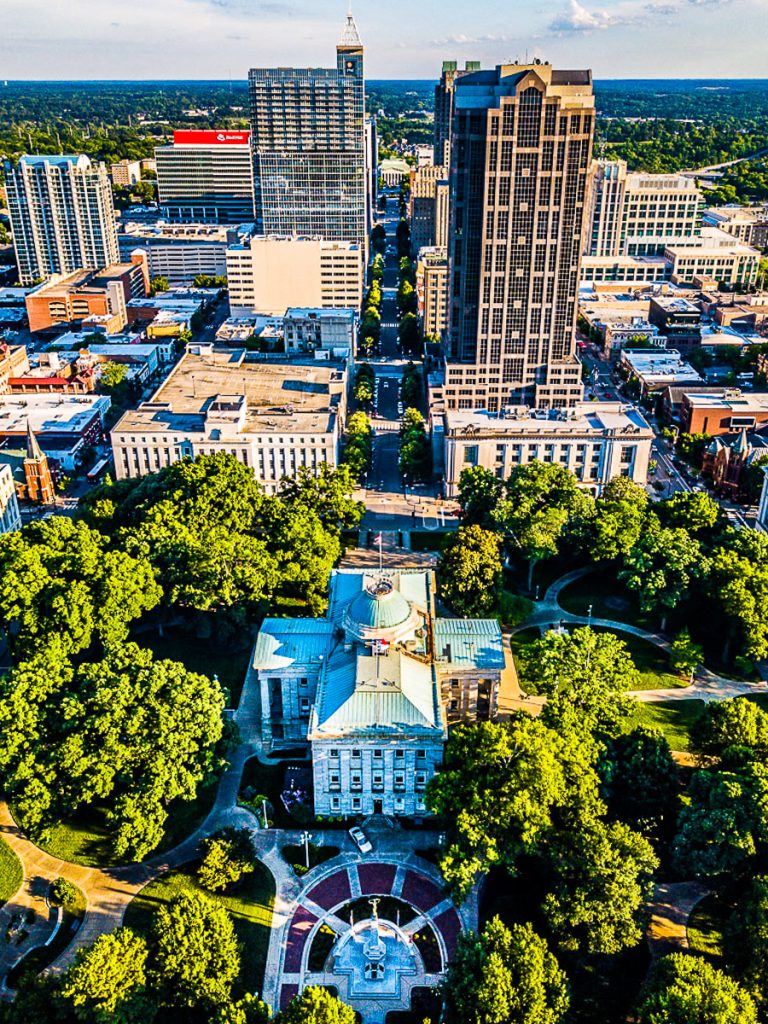 Buildings in downtown Raleigh surrounded by trees.