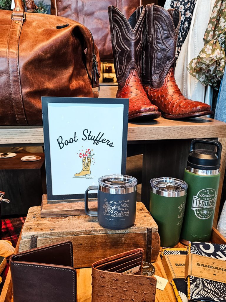 Coffee mugs and wallets on display in a store.
