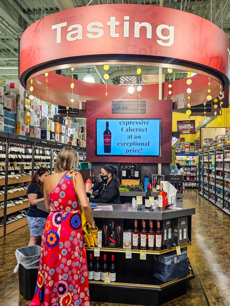 Lady tasting wine in a store.